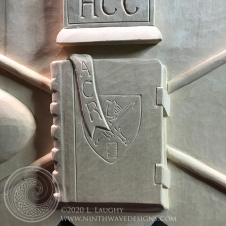 Lower center: A closed book with the School shield, with a bookmark bearing the initials A C R, represents the service of Amy C. Richards as Interim Rector.